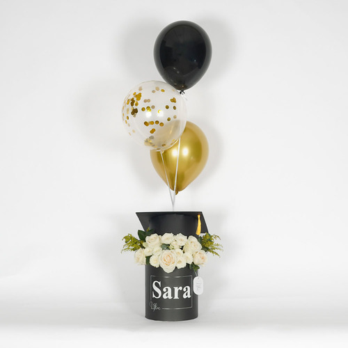 Sara - Black box with a graduation cap contains white rose, white baby rose and balloons  Height 110 Width 50