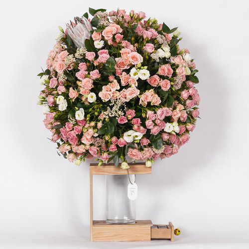 bizarre - This wooden basket, brown color contains king protea, eustoma, rise flower and mix of baby roses with Belgian chocolates.
 Height: 96cm Width: 80cm