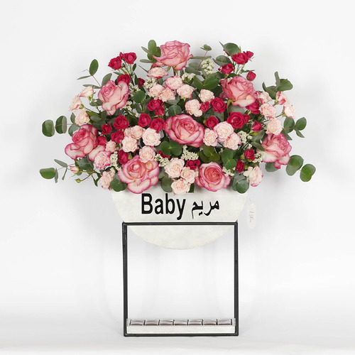 Mariam - wooden stand contains fuchsia beby rose, pink rose, pink baby riose with Belgian chocolate  Heghit 79 width 73