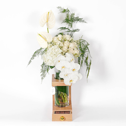 ادمير - Wooden stand with a glass vase contains white hydrangea, white roses, white anthurium, white orchid and Belgian chocolate  Height 98  Width 52