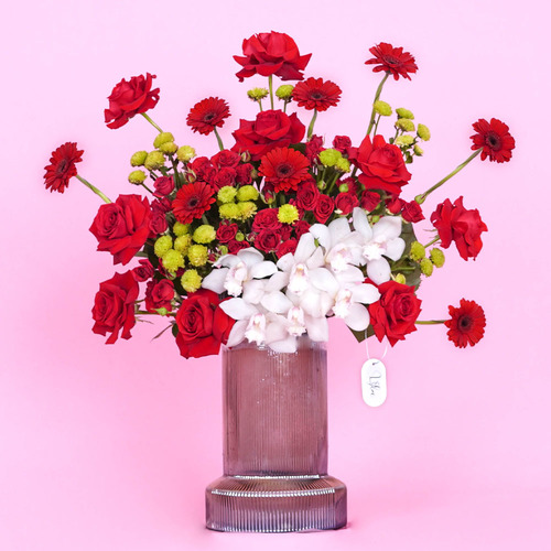 Love - Black  transparent glass vase contains red Gerbera, red roses, red baby rose and white cymbidium. Height 74 Width 69