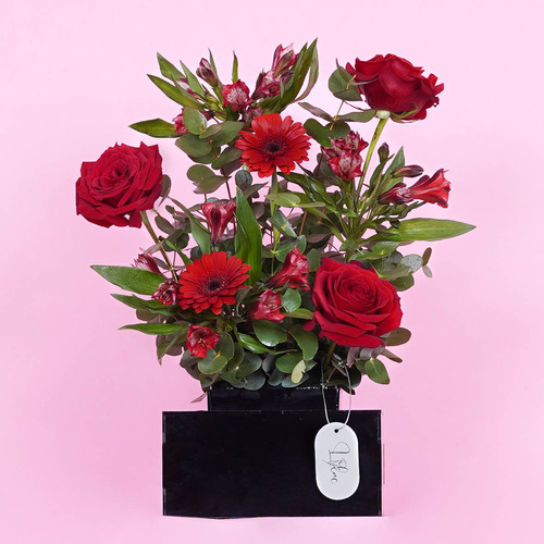 Bosi - Acrylic vase contains red roses, red Gerbera and red alstromiria Height 30 Width 29