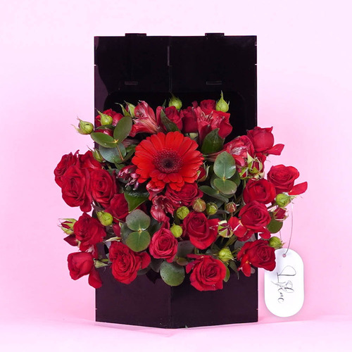 flora - Acrylic black vase contains red Gerber, red baby rose، red alstroemerias and Belgian chocolate Height 30  Weidth 29