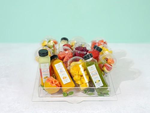A basket of sliced ​​fruit and juice