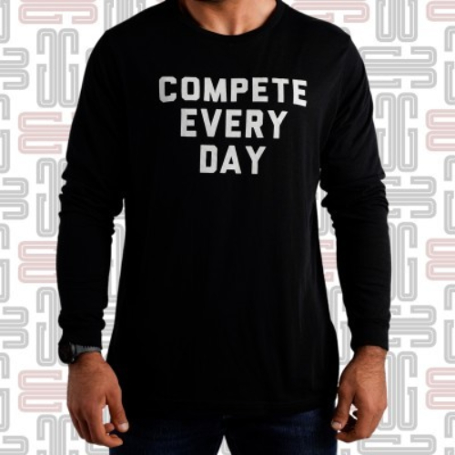 CED Classic Longsleeve T-Shirt - The Classic men’s longsleeve tee from Compete Every Day is simple in message and optimized for all-season performance. This athletic standard-fit top is made from a lightweight, flexible, cotton-poly-rayon blend material, ideal for the gym and comfortable enough for casualwear. Available in black with the words COMPETE EVERY DAY printed across the front in white. Compete Every Day is based in the U.S. and produces a wide range of motivational training apparel. As CEO Jake Thompson puts it, competing every day isn’t just about what you do in the gym, “it’s about taking control of your life. Refusing to let fear keep you from achieving your goals.” Material Type: 50% Polyester / 25% Cotton / 25% Rayon Care Instructions: Wash Cold, Dry Low