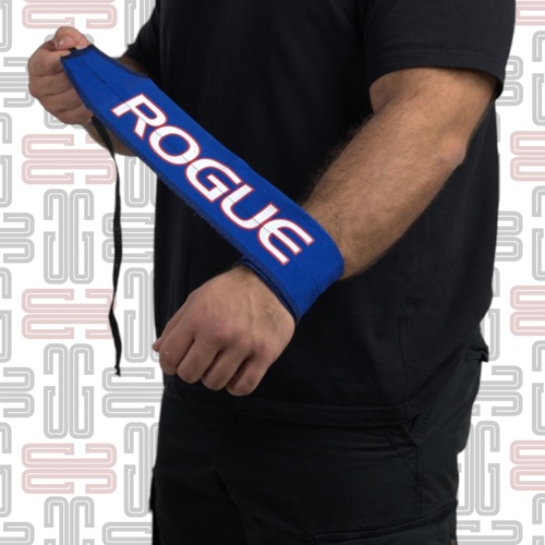 Rogue Wraps - Rogue Wraps offer athletes a streamlined, easy-to-adjust alternative to traditional, bulkier wrist wraps. Made in the USA, these 2.875” wide nylon straps replace the usual hook-and-loop system with a simple twist-tight design for fast, custom adjustments. So, instead of repeatedly wrapping and unwrapping your wrists from one movement to the next, you can just tighten the material for extra firm support on heavier lifts, then loosen it for a little more range of motion on the next. Whether your focus is Olympic lifting, power lifting, or GPP, the use of quality lifting wraps can help protect your wrists against stress and injury in the short term, while also reducing fatigue and wear and tear over the long term. With better wrist support, athletes can train longer, recover faster, and experience better cumulative results over time. Rogue Wraps are sold in pairs and are available in a variety of colors and designs.