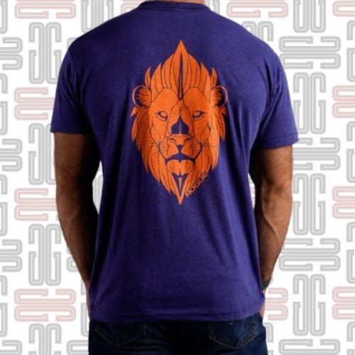 Lauren Fisher Lion T-shirt - The Lion T-shirt is the latest design inspired by 7x CrossFit Games competitor and perennial fan favorite Lauren Fisher. This cotton-poly blend unisex tee is available here in Blue and includes the Rogue “R” logo on the chest and an original lion-head graphic on the back in orange. Light, flexible, and breathable, crewneck athletic shirt Material Type 50% Polyester / 25% Cotton / 25% Rayon Care Instructions Wash Cold, Dry Low