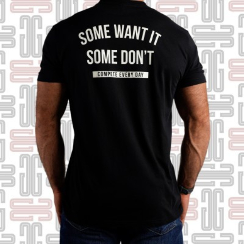 CED Some Want It T-shirt - This men’s crewneck tee from Compete Every Day is available in Black and features the motivational slogan “Some Want It, Some Don’t” across the back in white. COMPETE branding is also featured across the chest. Made from a pre-shrunk cotton-poly blend material, this design offers a free range of motion in the gym and optimal comfort as casual wear. Compete Every Day is based in the U.S. and produces a wide range of motivational training apparel. As CEO Jake Thompson puts it, competing every day isn’t just about what you do in the gym, “it’s about taking control of your life. Refusing to let fear keep you from achieving your goals.” Material Type: 60% Cotton / 40% Polyester Care Instructions: Wash Cold, Dry Low