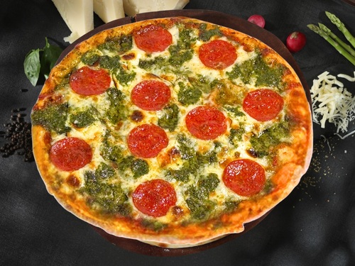 Pestoroni Pizza - Hand made thin crust pizza loaded with pepperoni, mozzarella cheese and with our signature pesto with neopolitana sauce .