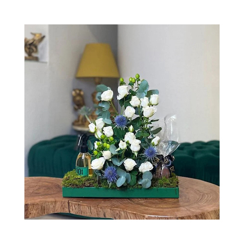 Titi - This bouquet contains white baby roses and green leaves. Comes with chocolates and 150ml spray. Height: 35cm  Width: 37cm