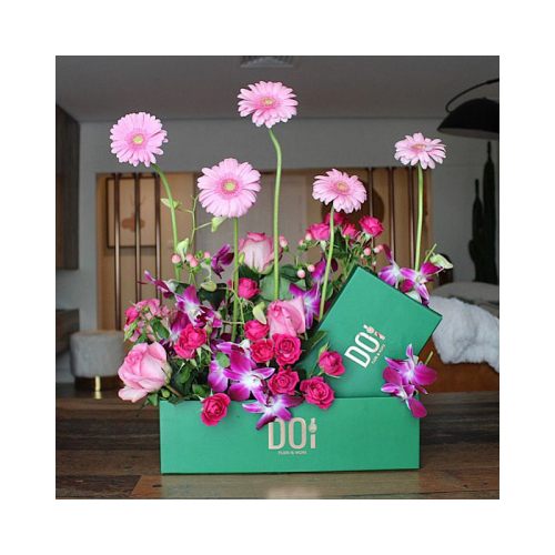 Cornwell - Green box contains pink gerbera, fuchsia baby roses, pink roses, purple baby orchid, green leaves and box of  chocolates. Height: 50cm Width: 35cm