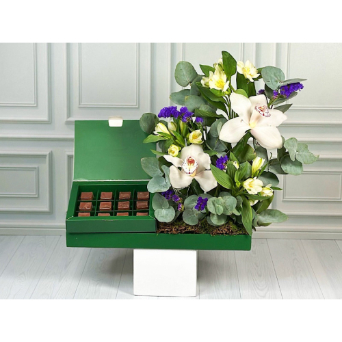 Happy - Green tray contains purple stats,  white orchid with a box of chocolates. Height: 50cm Width: 35cm