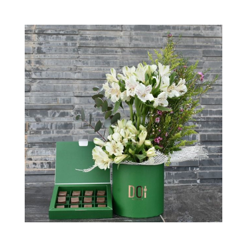 Kiev - This green box contains white alstroemeria flowers with a box of chocolates. Height: 30cm Width: 15cm Sell by: Quantity