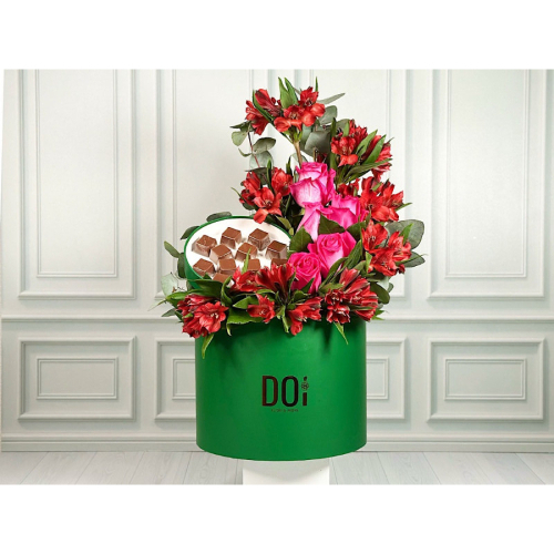 Romy - A green box contains red roses alstroemeria green leaves and chocolate. Height: 50cm Width: 25cm