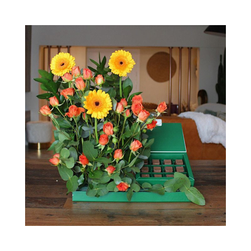 Solovina - This tray contains yellow gerbera and orange baby roses with green leaves and chocolates. Height: 40cm Width: 35cm