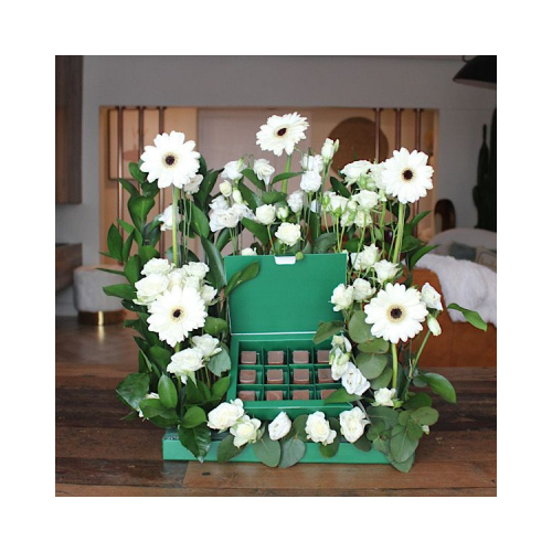 Toscona - This tray contains white gerbera and white baby roses with green leaves and chocolates. Height: 40cm Width: 35cm