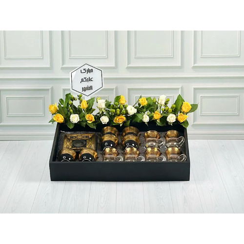 Niqsa Tray - Wood tray contains set of coffee and tea cups with white and yellow baby roses, green hypericum, green leaves and acrylic. Height: 30cm width: 40cm