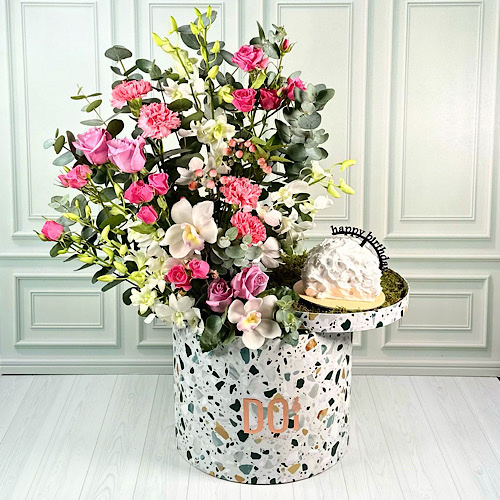 Doi Kwt  - Joy - Terrazzo box contains Pink Roses, Pink Carnation, Pink Hypericum, White baby orchid, White Cymbidium, Fuchsia and Pink baby roses and green leaves with happy birthday cake.Height: 70cmWidth: 40cm