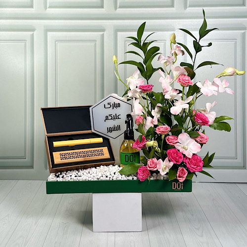 Ramadan Kareem - Green tray contains pink and fuchsia baby roses, pink baby orchid and green leaves with bokhour, a 150ml spray and acrylic stick.
Height: 40cmWidth: 35cm