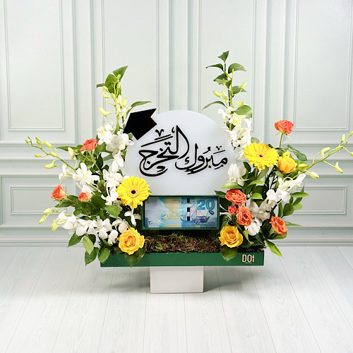 Ora - Green tray contains Yellow grabera, orange and yellow baby roses, white baby orchid and green leaves with money box and congrats acrylic.
Height: 40cmWidth: 35cm