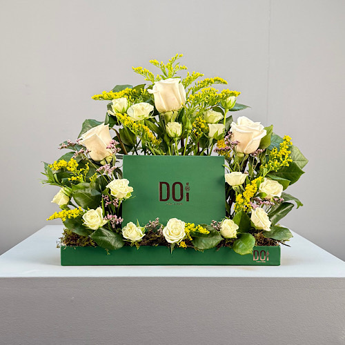 Doi Kwt  - Viki - Green tray contains white baby roses and rose, Yellow solidago with box of Belgium chocolate.  Height: 40cm  Width: 30cm