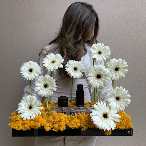 Bed of Gerberas I - Gerberas arranged in a black tray with 100ml perfume, 3 tulles of ma'mol and chocolates 
 L 50cm * H 25cm*Flower kind and color may slightly
differ based on availability.