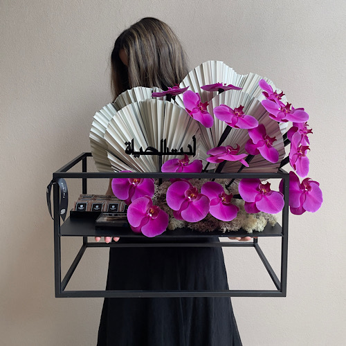 My Life - An arrangement of flowers in a black stand with Vietnamese bekhor and chocolates 
 L 55cm * H 65cm*Flower kind and color may slightly
differ based on availability.