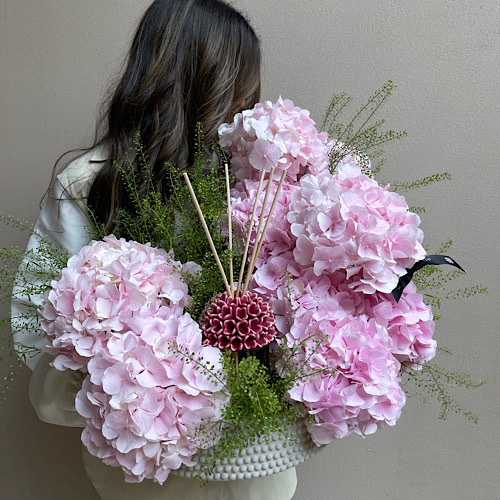 Pink Clouds - An arrangement of pink hydrangeas with Riccio Caprese diffuser in a concrete vase*Flower kind and color may slightly
differ based on availability.