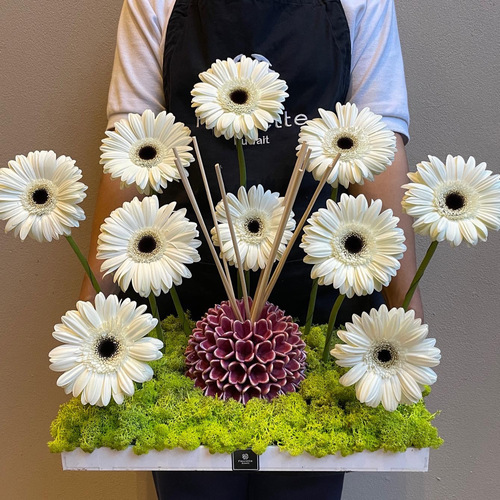 Ruby Jewel - An arrangement of gerberas in a white tray. You can add chocolates or Riccio Caprese diffuser 18cm as shown in picture*Flower kind and color may slightly
differ based on availability.