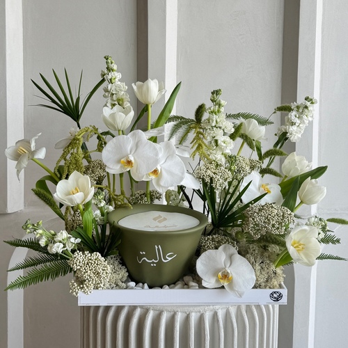 Luxury Nature - An arrangement of flowers with Shamaa candle size 21cm *write the desired name on the candle in the  message box *Flowers color and kind may slightly differ based on availability