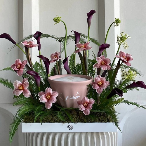 Charmed - An arrangement of flowers with 21cm Shamaa candle *write the desired name on the candle in the message box *Flower color and kind may slightly differ based on availability