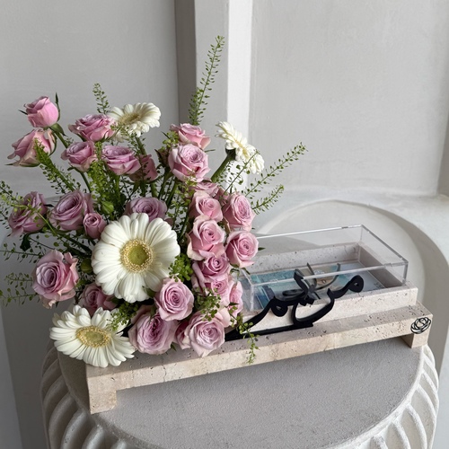 Purple melow - An arrangement of flowers in a travertine tray *write the desired name or phrase on the tray in the message box *Flower color and kind may differ slightly based on availability L40 H25