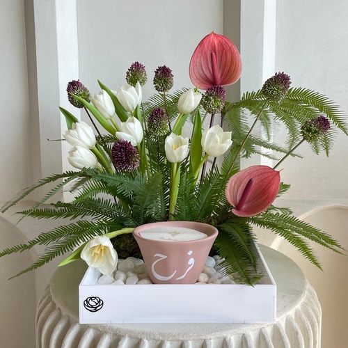 Tropical Flair I - An arrangement of flowers with customized 12cm candle in a white tray. * Write the desired name in the message box.