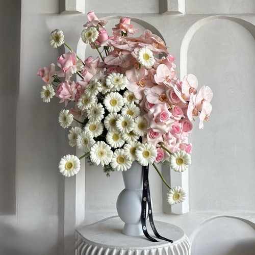 Blooming Bliss in Large - An arrangement of roses, gerberas, and orchid in a tall white vase. *Flower color and kind may slightly differ based on availability