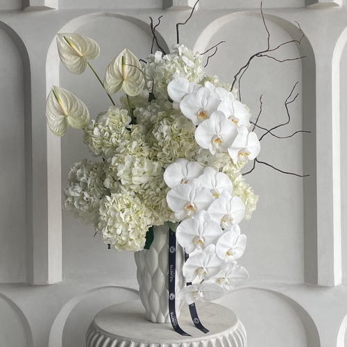 White beauty - An arrangement of flowers in a tall white vase. H 97cm *Flower’s color and kind may slightly differ based on availability.