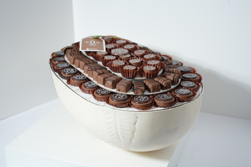 Oval Luxury tray - A luxurious tray with a refined design, featuring 620g of premium filled chocolates in standout flavors: Salted Gianduja, Salted Pistachio, and Cheesecake Pecan. Elegantly arranged in a decorative dish — perfect for gifting or upscale occasions.
