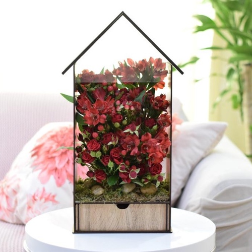 Red House - A beautiful house containing baby rose flowers, astomaria, grass, and green plants, in addition to 20 luxurious pieces of chocolates