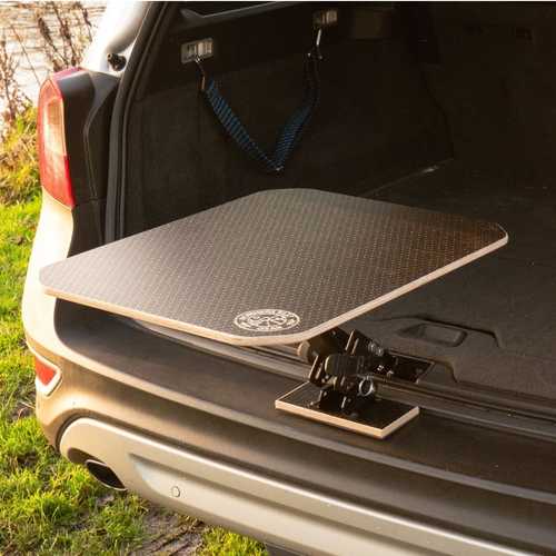 Car Picnic Table - The all new Car Bar! Now fits a range of vehicles.  Sets up in 10 seconds Fits most cars vans ✓  Boot-mounted Folds down flat Black hexa ply 600x450x12mm tabletop Holds 15kg/30lbs Angle & height adjustable No modifications to your vehicle Powder-coated aluminium leg UK designed & made Ditch those burly camping tables and fiddly chairs for those quick pit stops and trips! Embrace the ease of The Car Bar, designed to be as quick and easy as possible to set up and take down. Transforms the boot of your car into a table and chairs seconds. Whether your stopping for a quick cuppa, or pitched up and bringing out the camp stove and beers, The Car Bar is the perfect platform! Note: The Car Bar isn't compatible with VW transporters with a self-opening/soft close tailgate.