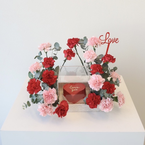 Love cake - A travertine tray that contains carnations flowers with a mini cake.