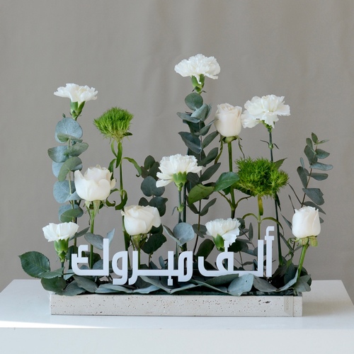 Vera hajj - A travertine tray that contains a fresh roses and carnation. 
 Width 40 cm Height 45 cm