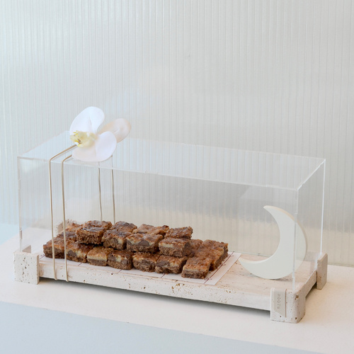 yoza - Travertine  tray contains chocolates with wooden moon with acrylic cover and orchid flower