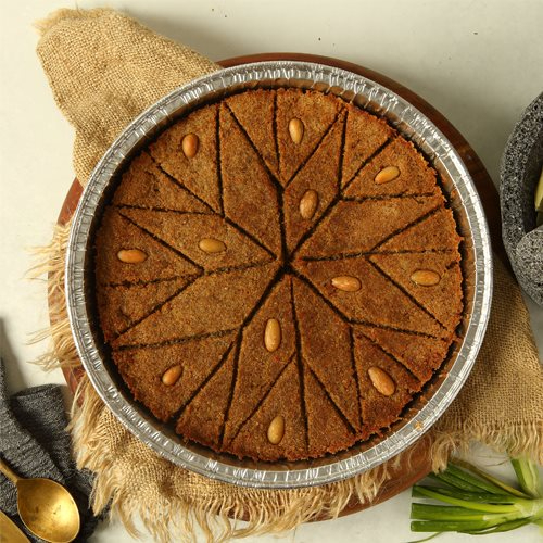 Kibbeh bel Seniyeh - burghol kibbeh dough stuffed with meat & pine