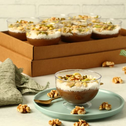 Meghli - rice pudding spiced with carawya & cinnamon garnished with mif nuts