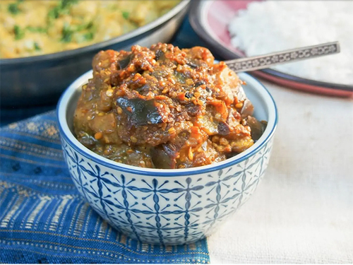 Lokmat Beit - Eggplant Roasted Achar - Achar made with Kuwaiti oven-roasted eggplant, mixed with spices and sweet-sour sauce, without hydrogenated oils, goes perfectly with daily meals.   Ingredients: roasted eggplant, virgin olive oil, tomatoes, onion, ginger, garlic, tomato paste, mustard seeds, coriander seeds, coriander powder, turmeric powder, cumin seeds, cumin powder, bay leaves, chili powder, green chili, sea salt, black pepper, natural vinegar.   No added sugar