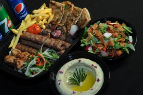 Mixed Grills family size  ( 4 persons ) - Mixed grilles : 2 shish tawook skewers , 2 tikka skewers , 4 skewers kebab, 4 arayes meat, half grilled chicken, served with french fries , humos ,salad & 1 ltr soft drink