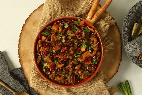 Lokmat Beit - horaa osbaa - lentils , macaroni ,cooked with pomegranate sauce , topped with pomegranate seeds , fried onion & bread