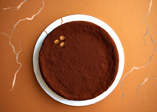 Chocolate Hazelnut Flourless Cake - Rich and fudgy chocolate cake filled with hazelnut paste, dusted with cocoa powder. Flourless Allergens: Dairy, Gluten free Contains Hazelnut Nuts