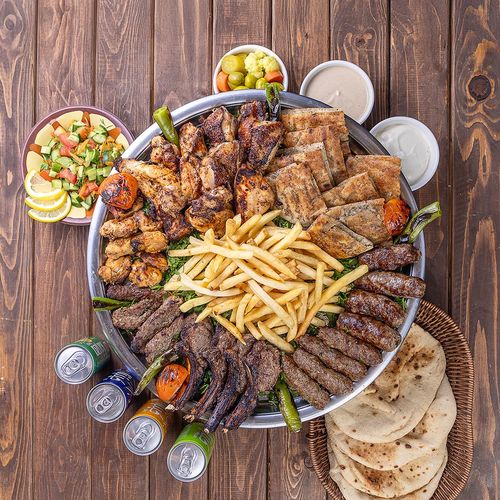 Tabliah Restaurant - Tabliah Family Tray - 4 lamp chops 4 tarp 2 kabab 2 kofta 2 shish tawooq 2 Hawawshi 1 grilled chicken with salad bread Tahina garlic and soft drink
