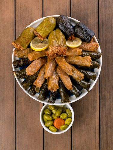 Mix Mahashi Small - A combination of stuffed Vegetables, such as Peppers, Zucchini, and Grape leaves, filled with a Fragrant mixture of Rice, Herbs, and Spices.