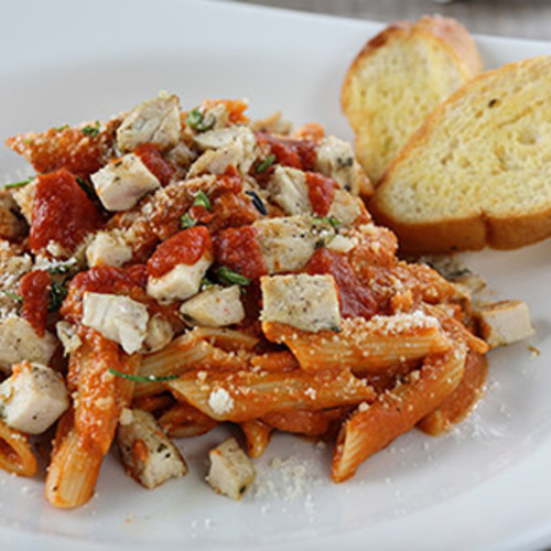 Zephora Pink Pasta - Grilled chicken breast, penne pasta with creamy mushroom & homemade tomato sauce topped with grated parmesan, served with garlic bread.